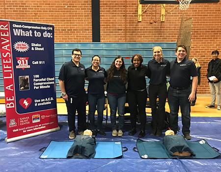 UA student volunteers taught chest-compression-only CPR at Pueblo High School's Family Night.