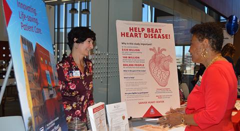 Cindy Schrag, clinical research coordinator discusses the UA Sarver Heart Center biorepository with Wanda F. Moore.