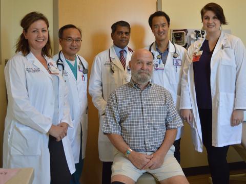 Chip Rock (seated), the first “low-risk” TAVR patient at Banner – University Medical Center Tucson, came in for a follow-up appointment 11 days after the procedure and played golf on day 12, following the minimally invasive heart-valve replacement procedure. TAVR team members from left: Erin Scala, RN, BSN, Keng Pineda, MD, PhD, Kapil Lotun, MD, Toshinobu Kazui, MD, PhD and Devan Lodge, RN, MSc, CCRN.